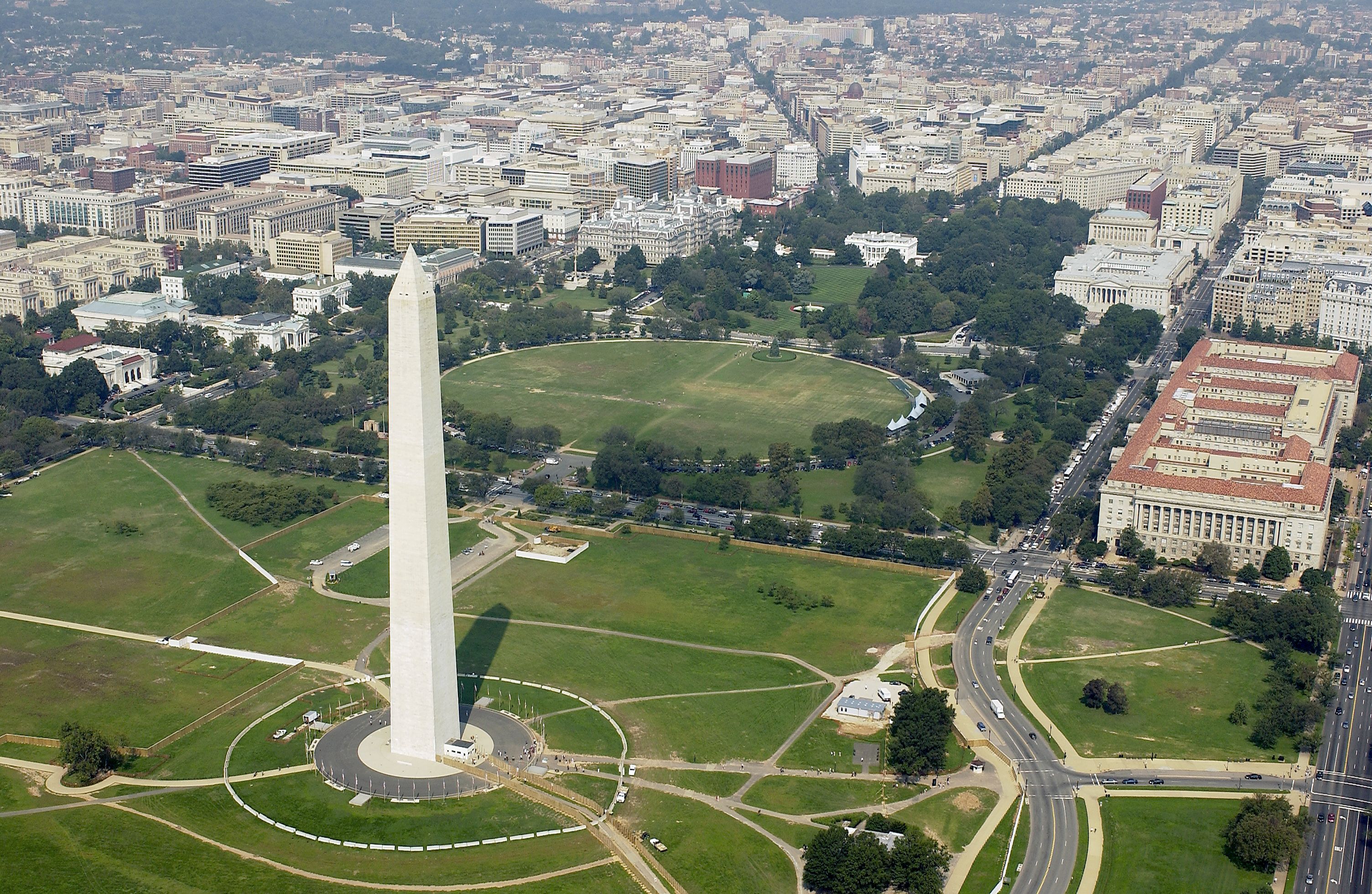 Aerial view of the Washington Monument with the White House beyond.