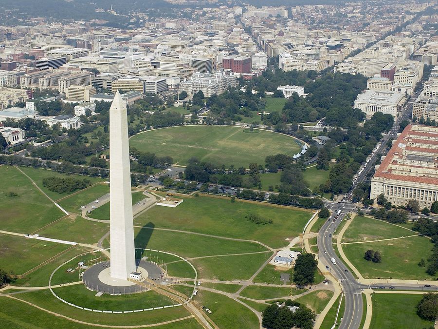 Aerial view of the Washington Monument with the White House beyond.