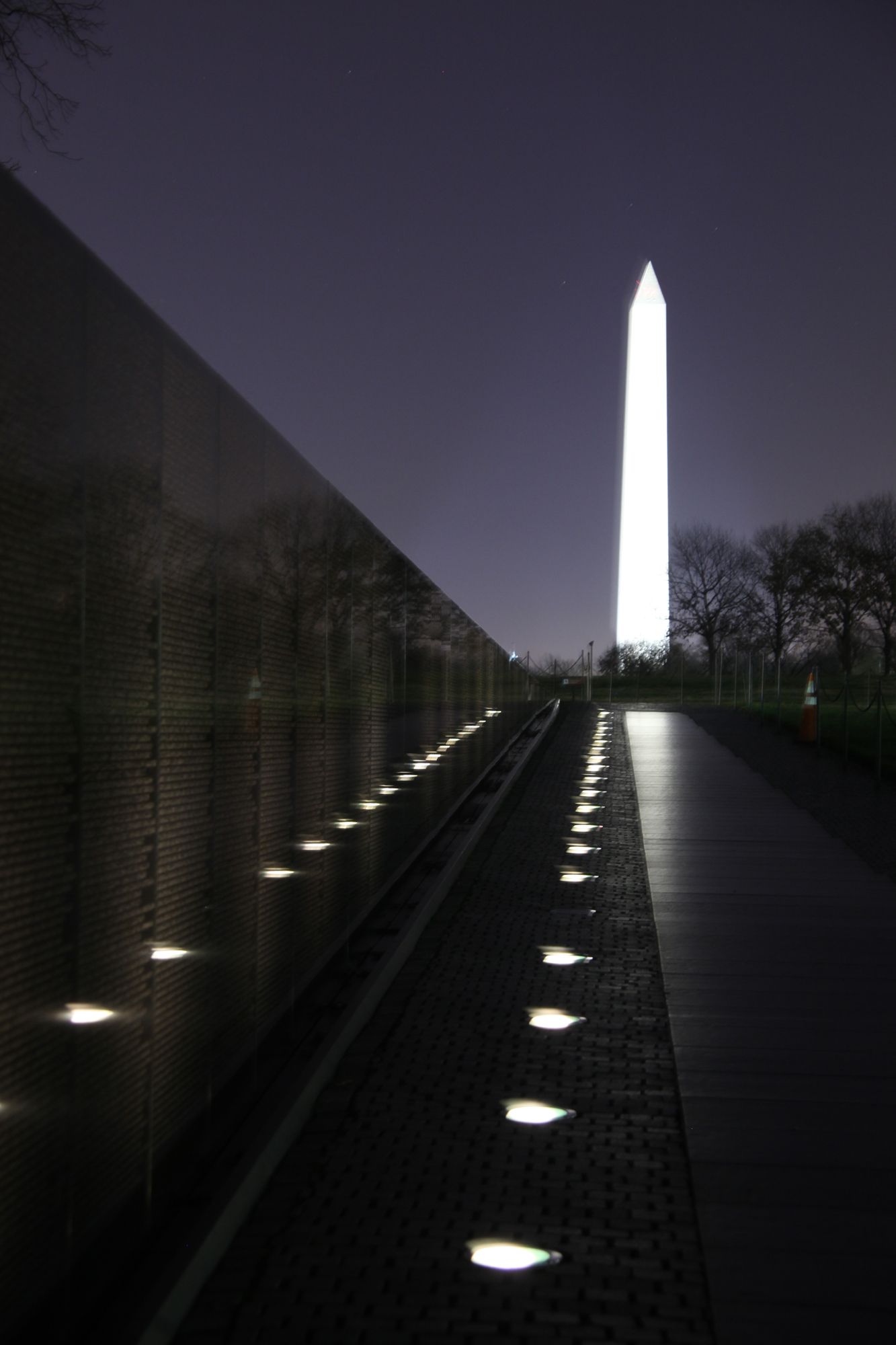 Visitors reading names inscribed on the Vietnam Veterans Memorial wall.