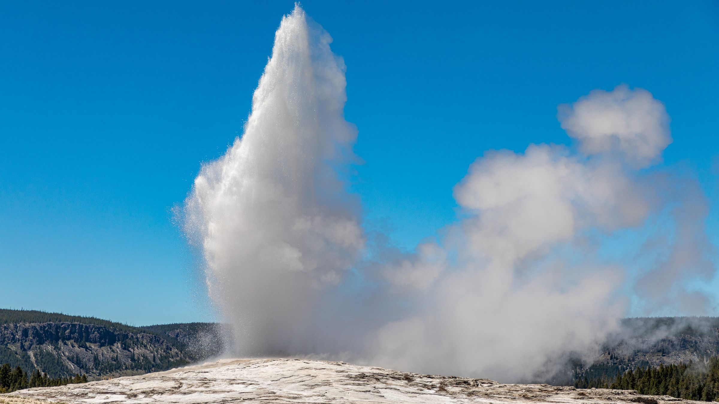 Old Faithful geyser erupting in Yellowstone National Park.