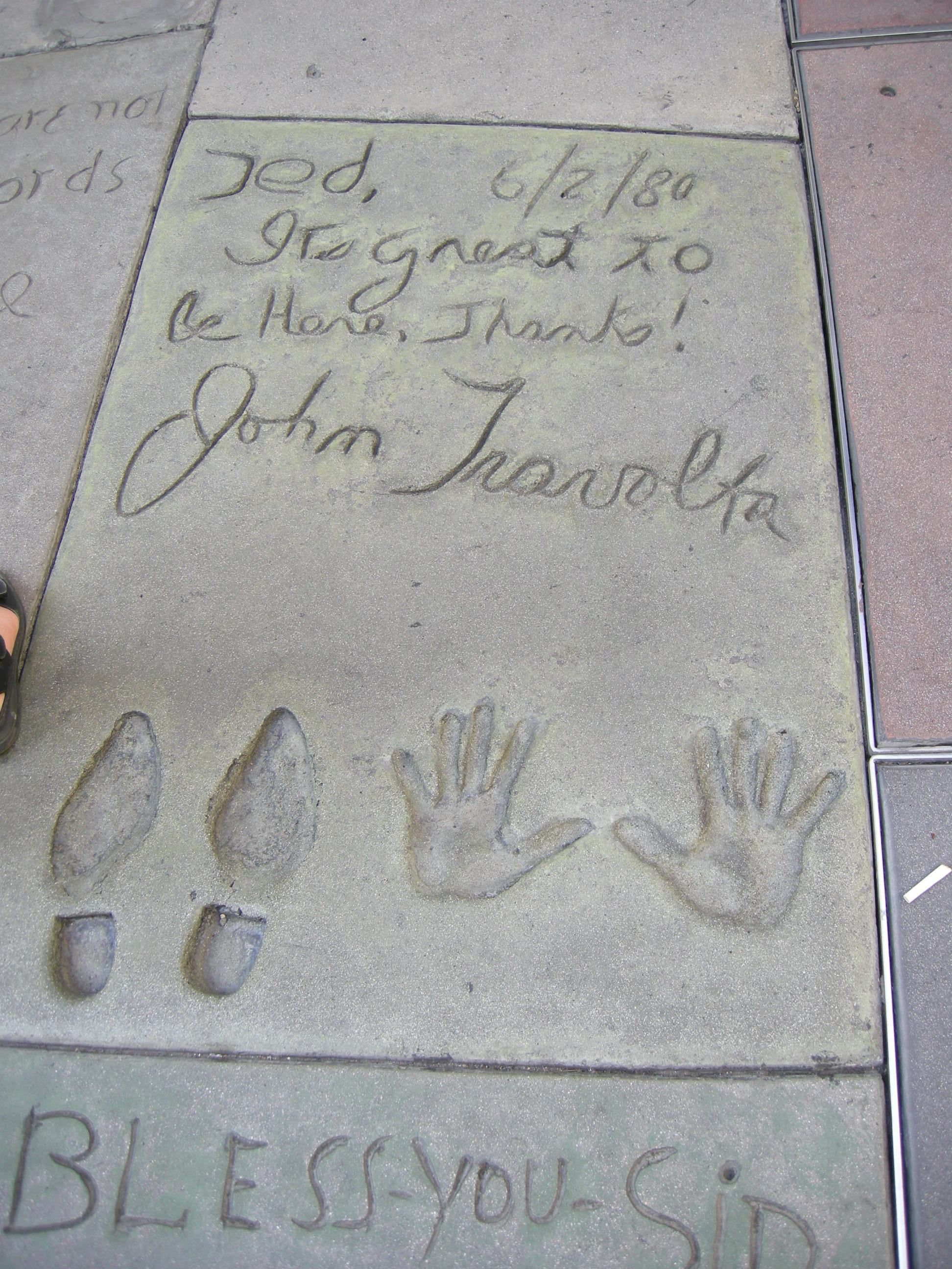 John Travolta's handprints and signature in the theater's forecourt.