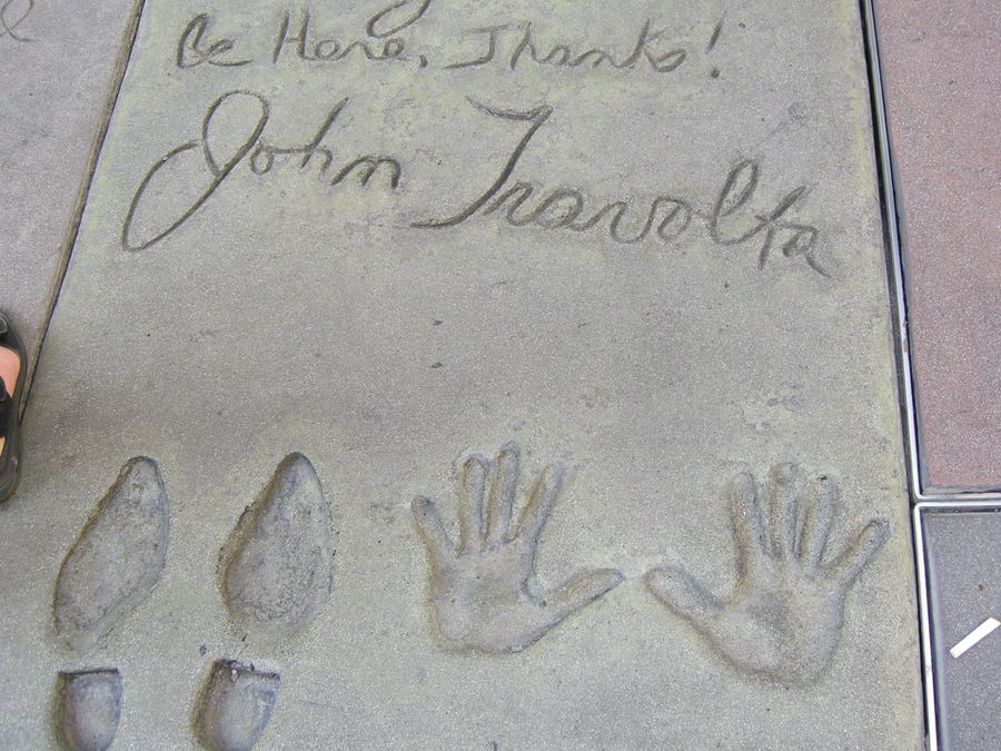 John Travolta's handprints and signature in the theater's forecourt.