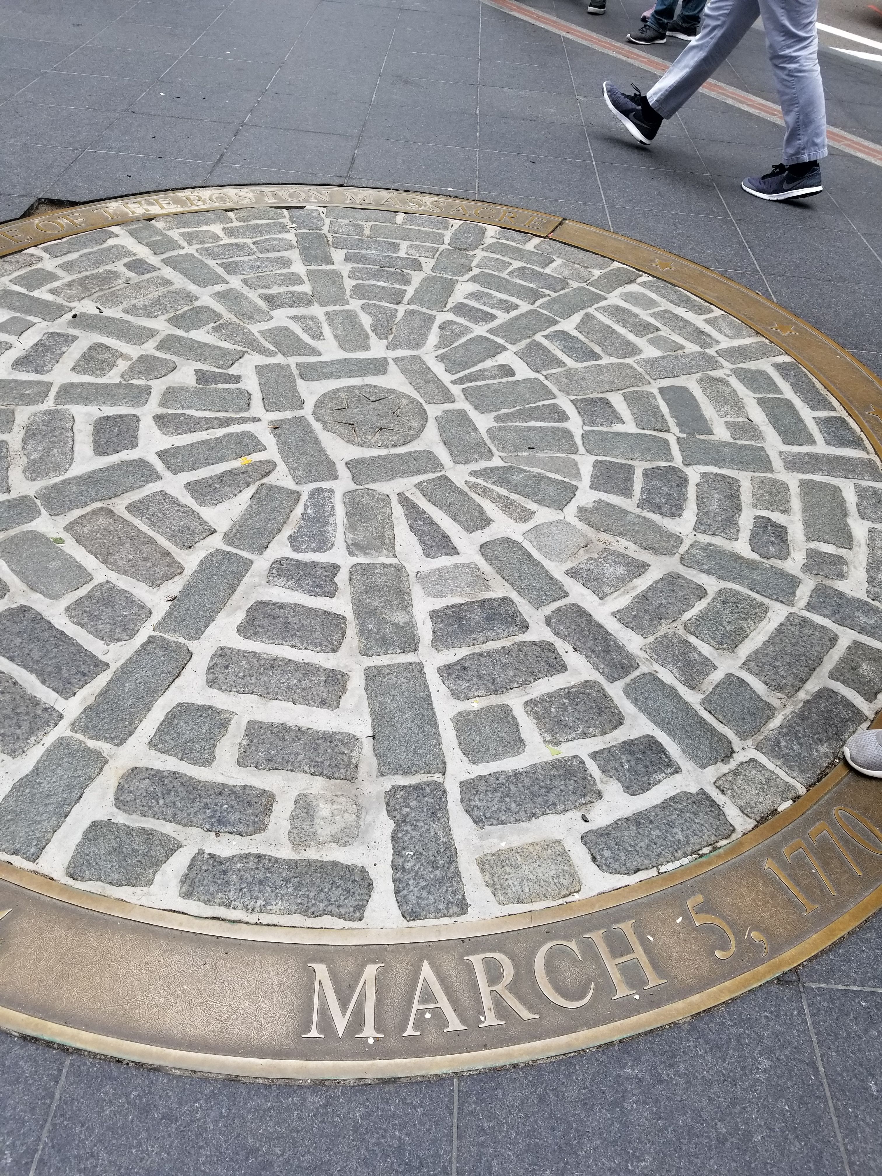 The cobblestone marker outside the Old State House marking the Boston Massacre site.