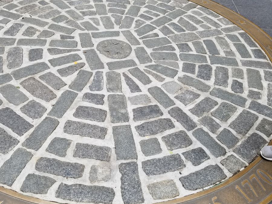 The cobblestone marker outside the Old State House marking the Boston Massacre site.