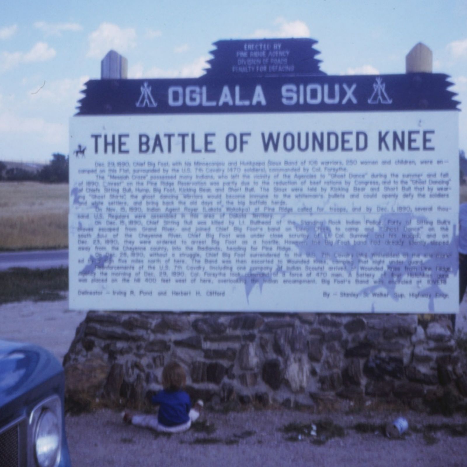 A historic marker sign at the Wounded Knee site, photographed around 1971.