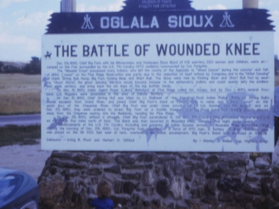 A historic marker sign at the Wounded Knee site, photographed around 1971.