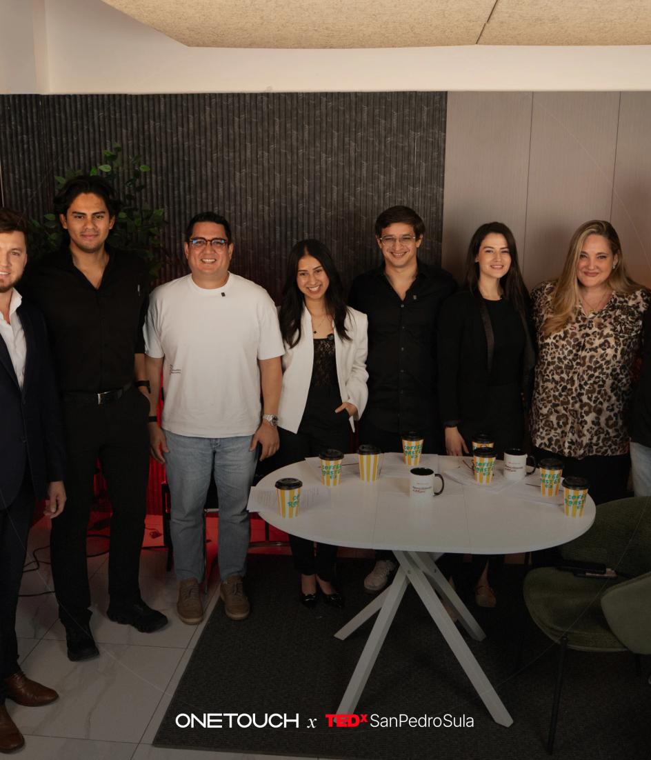 Onetouch team gathered around a white table in a photo studio, announcing the Onetouch x TEDxSanPedroSula 2026 alliance under the theme "Rewriting the future."