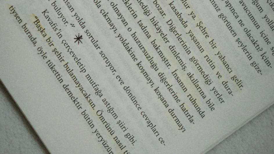 An open book with a single passage marked in highlighter and the rest of the page left untouched