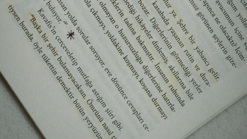 An open book with a single passage marked in highlighter and the rest of the page left untouched
