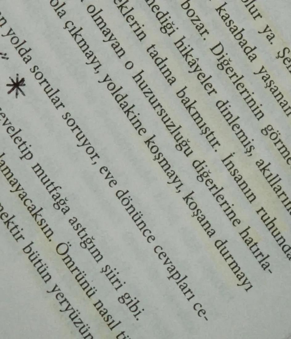 An open book with a single passage marked in highlighter and the rest of the page left untouched