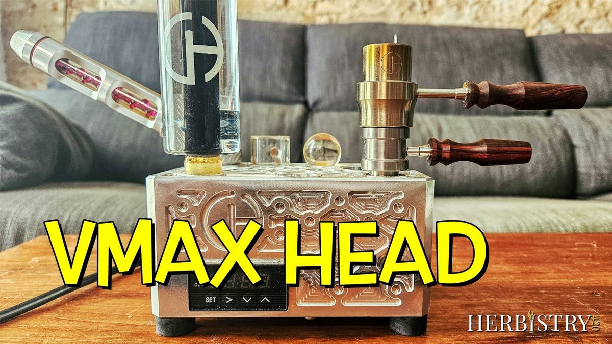 Cannabis Hardware VMAX ball vape head with wooden handles on an Airstream desktop base, next to its quartz insert and a tube of ruby balls