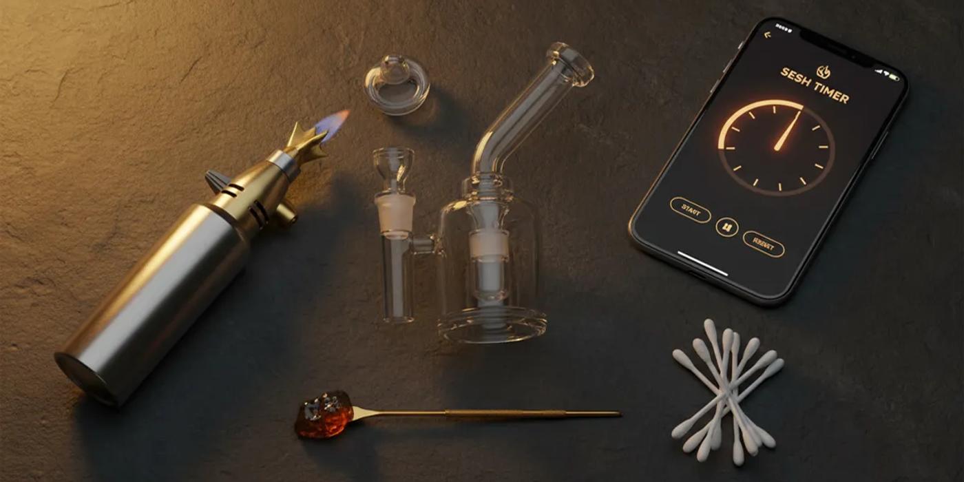 Complete dab setup flat-lay with rig, banger, torch, and accessories
