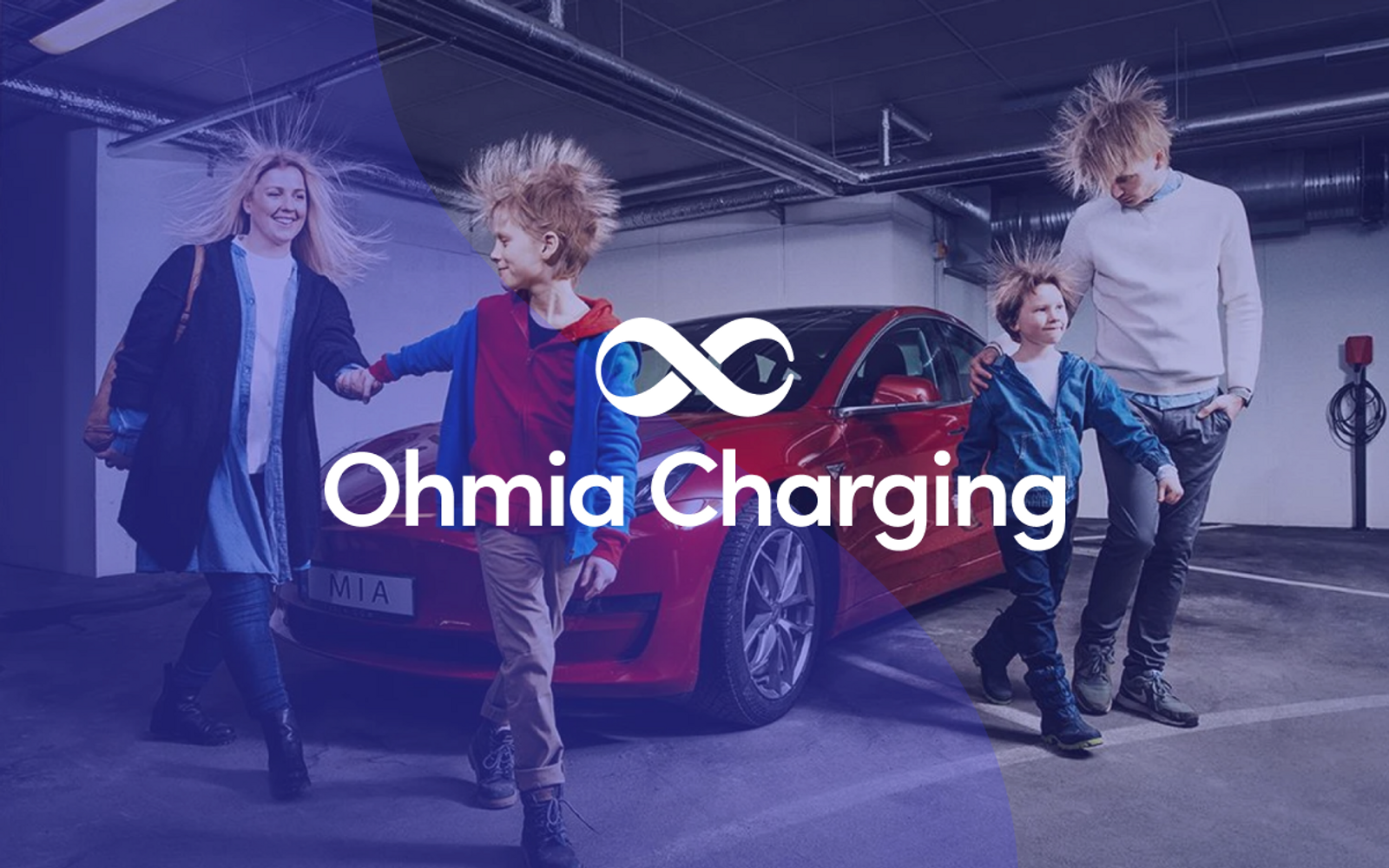 A picture of a family in front of a car, with a blue transparent overlay and Ohmia Charging logo over it