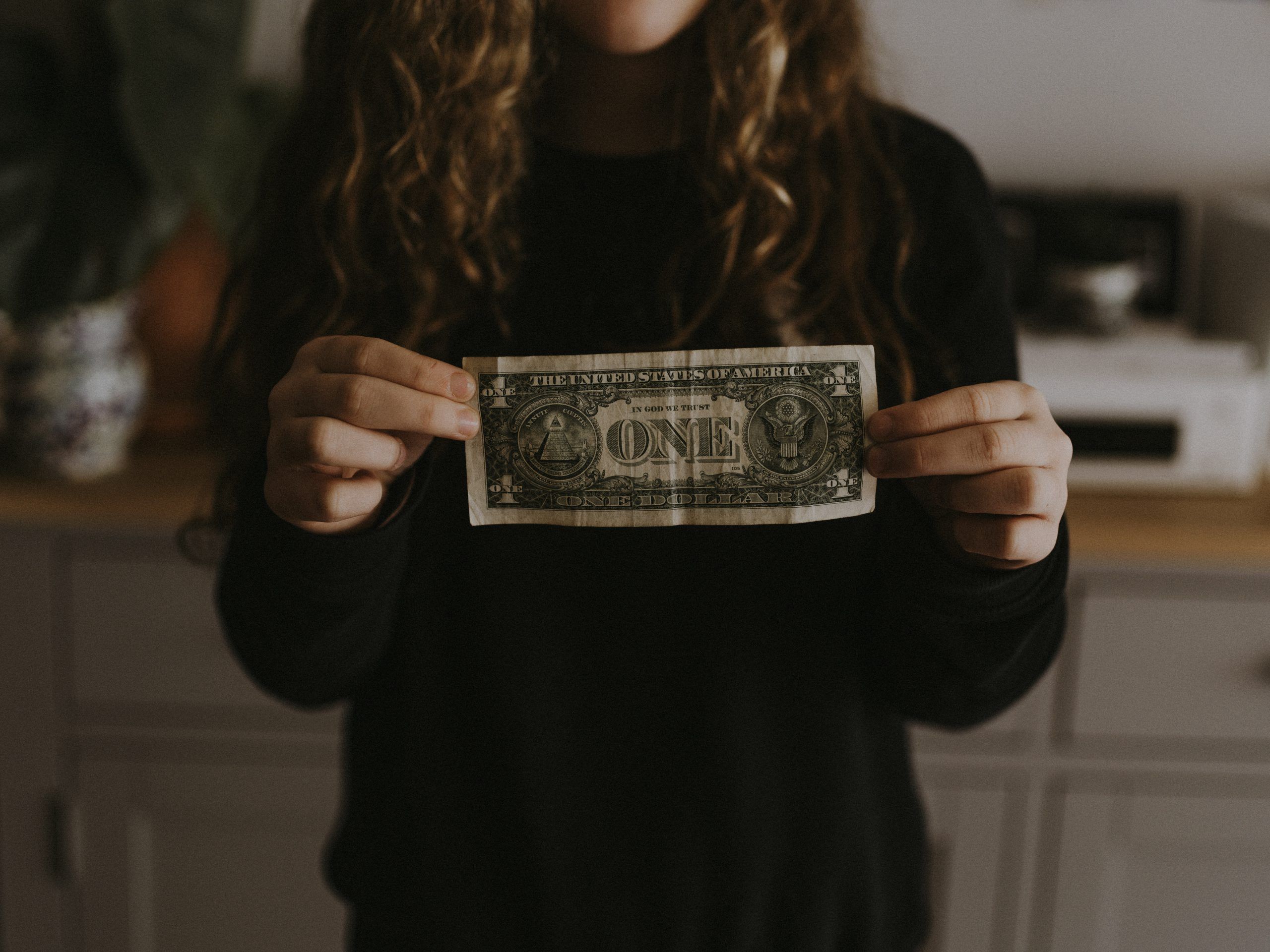 girl holding dollar