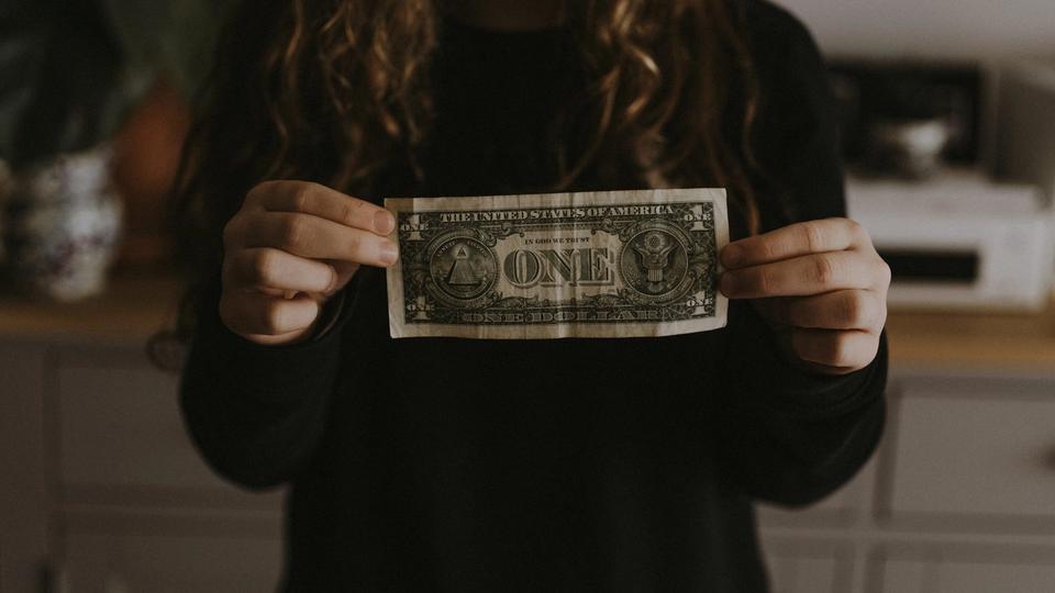 girl holding dollar