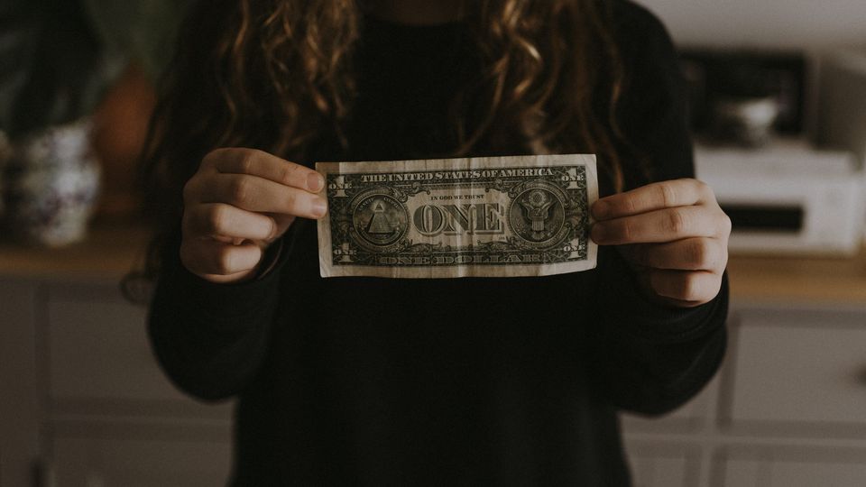 girl holding dollar
