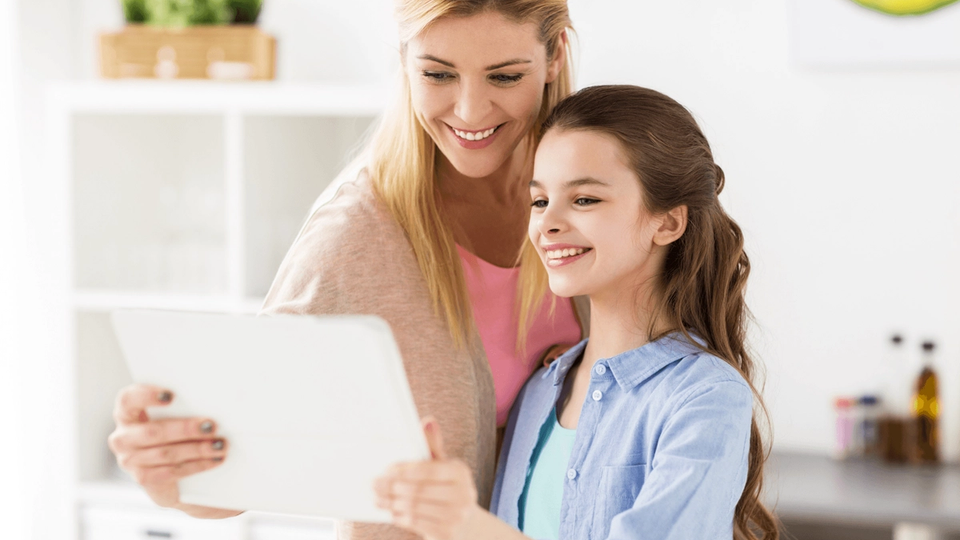 Mother and daughter with a tablet