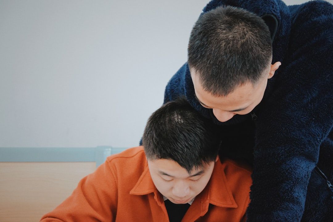 Parent sitting with child providing encouraging support during math practice