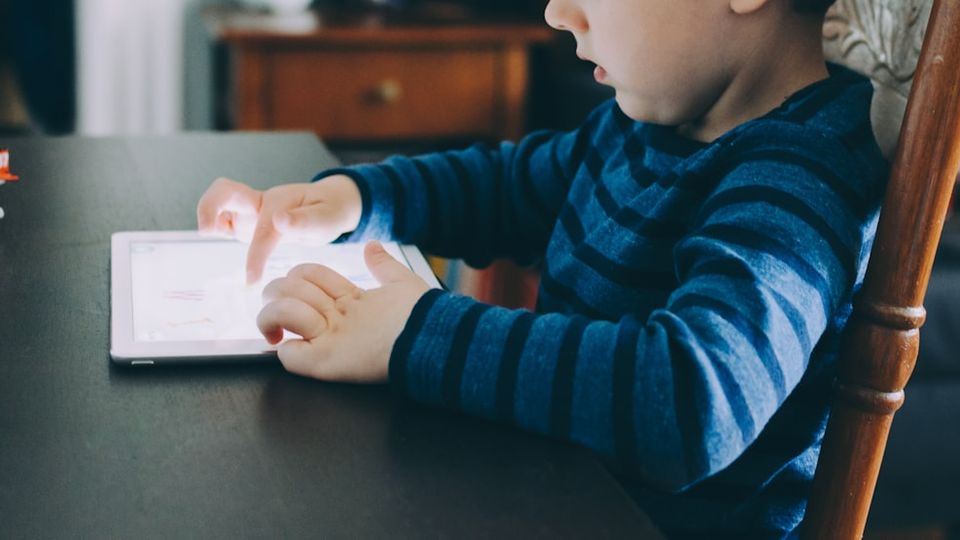 Child using a tablet for personalized online math learning at home