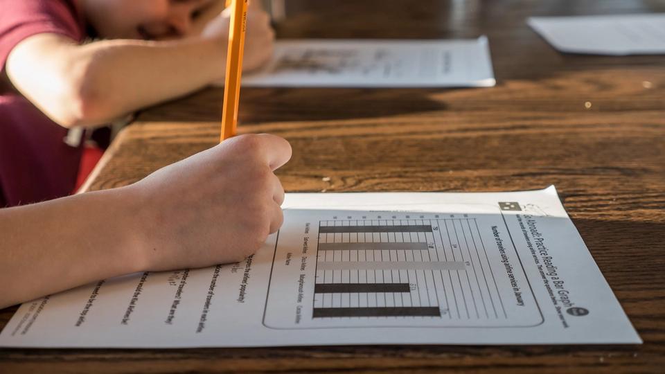 Kid working on math problem