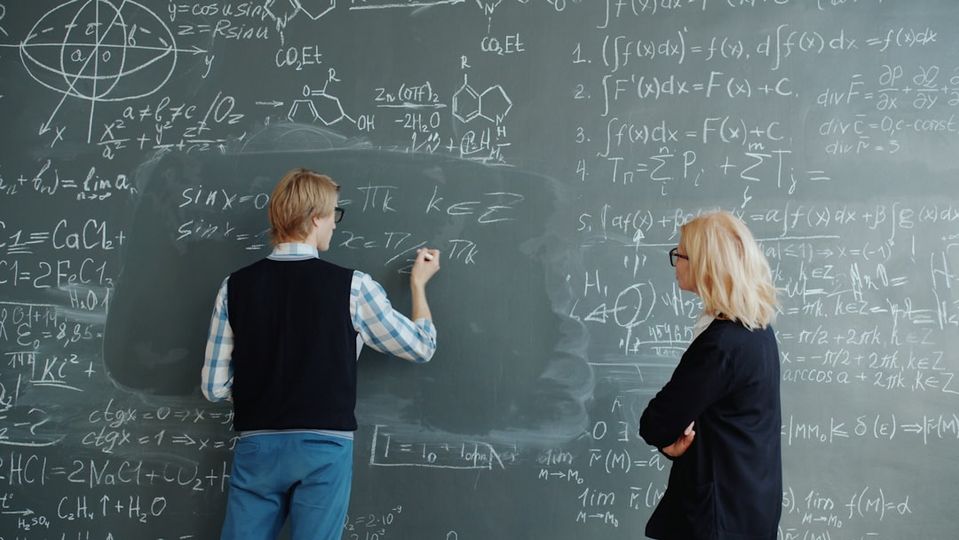 Instructor teaching math concepts to student in learning center environment