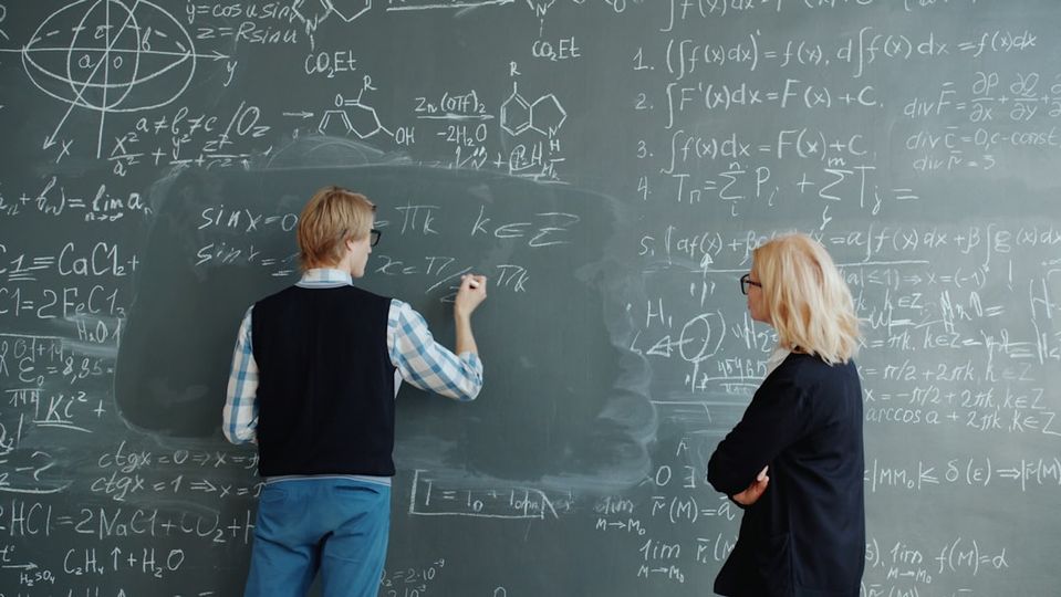 Instructor teaching math concepts to student in learning center environment