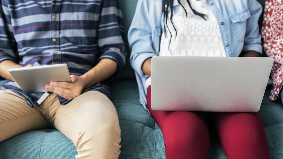 Cropped man and woman using electronic devices