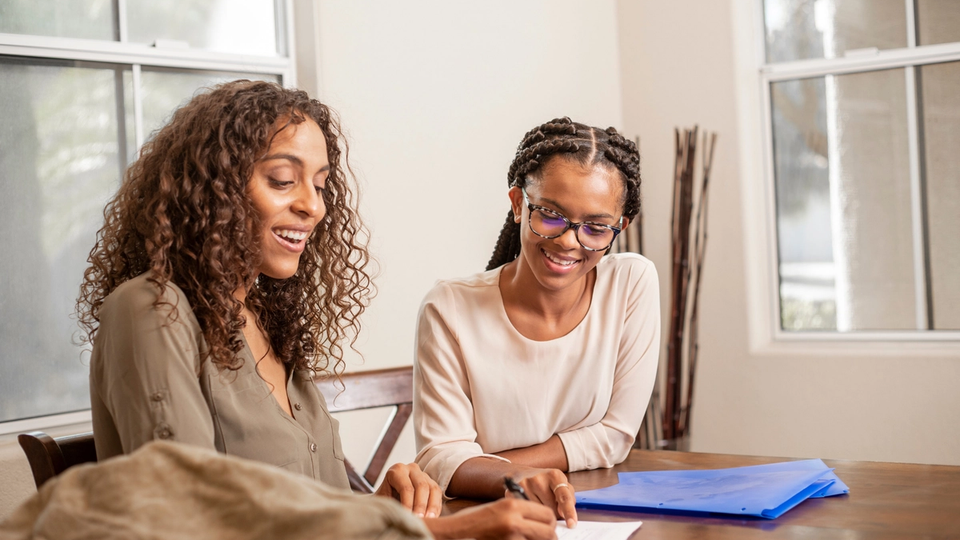 A young girl and her math tutor collaborating on solving problems, building confidence, and improving math skills through personalized learning.
