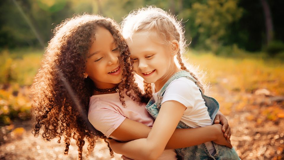 Two young girls hugging