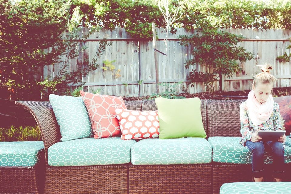 Girl sitting on a couch using tablet
