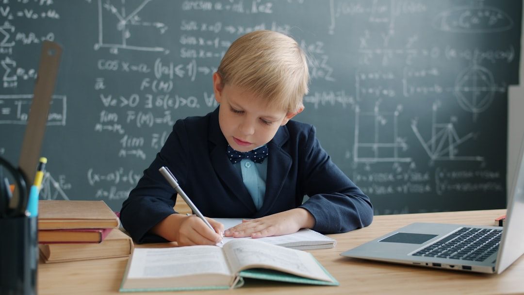 Child looking thoughtful while reviewing corrected math work with parent nearby