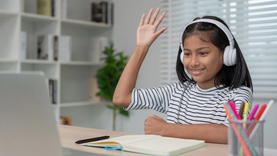 Smiling student engaged in online tutoring session, showcasing the benefits of personalized learning and academic support.