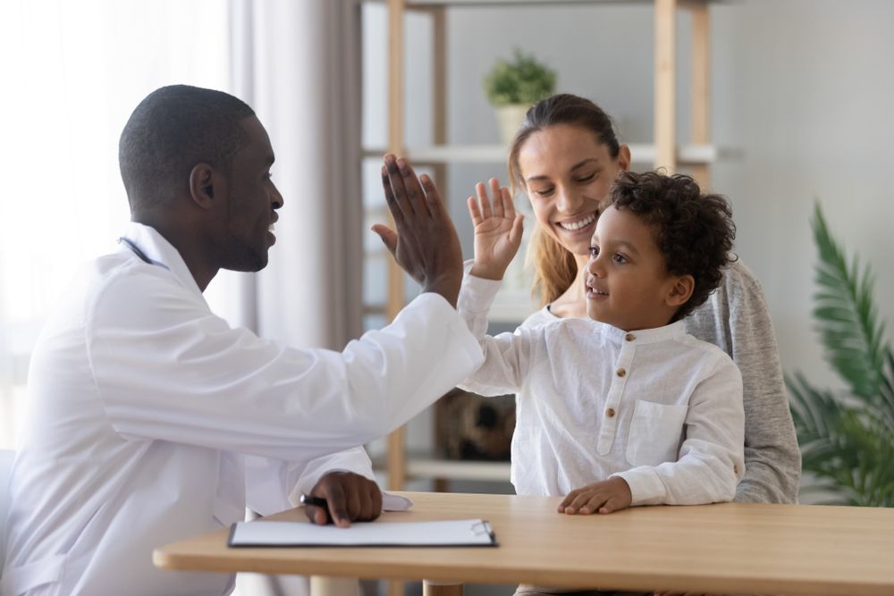 Family happy and high fiving about homework.
