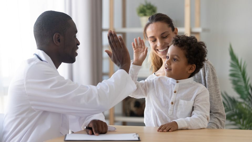Family happy and high fiving about homework.