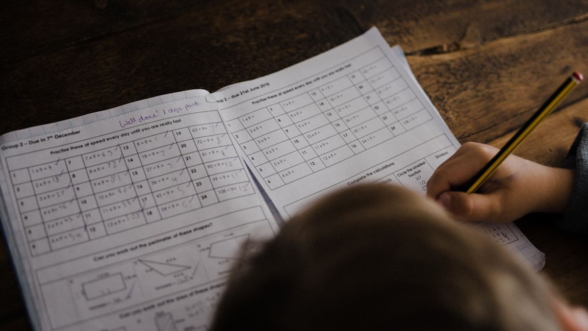 Child doing math homework at desk