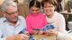 Girl playing cards with grandparents