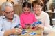 Girl playing cards with grandparents