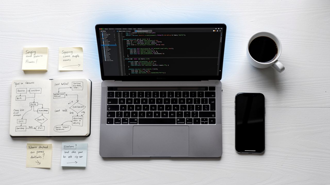 โต๊ะทำงานนักพัฒนาพร้อมเครื่องมือวางแผนและเขียนโค้ด