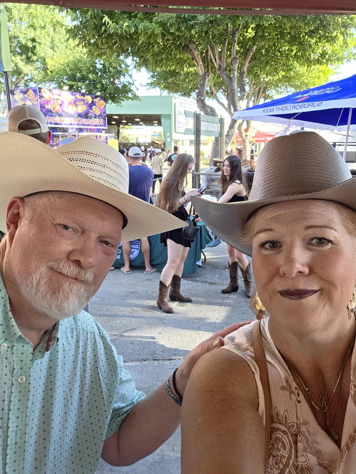 Couple in cowboy hats enjoying the California Mid-State Fair in Paso Robles