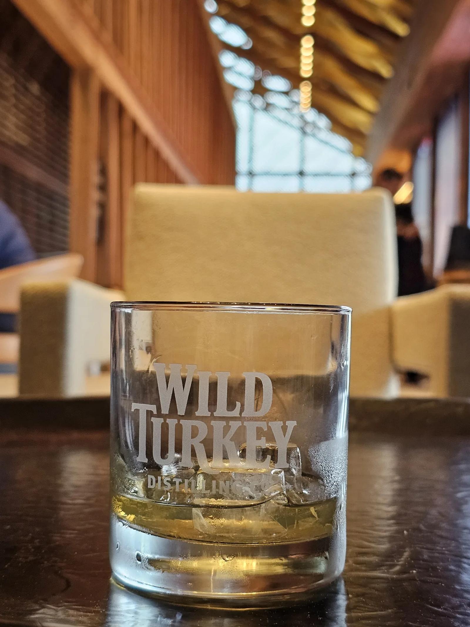 Three measured bourbon pours arranged from light to rich