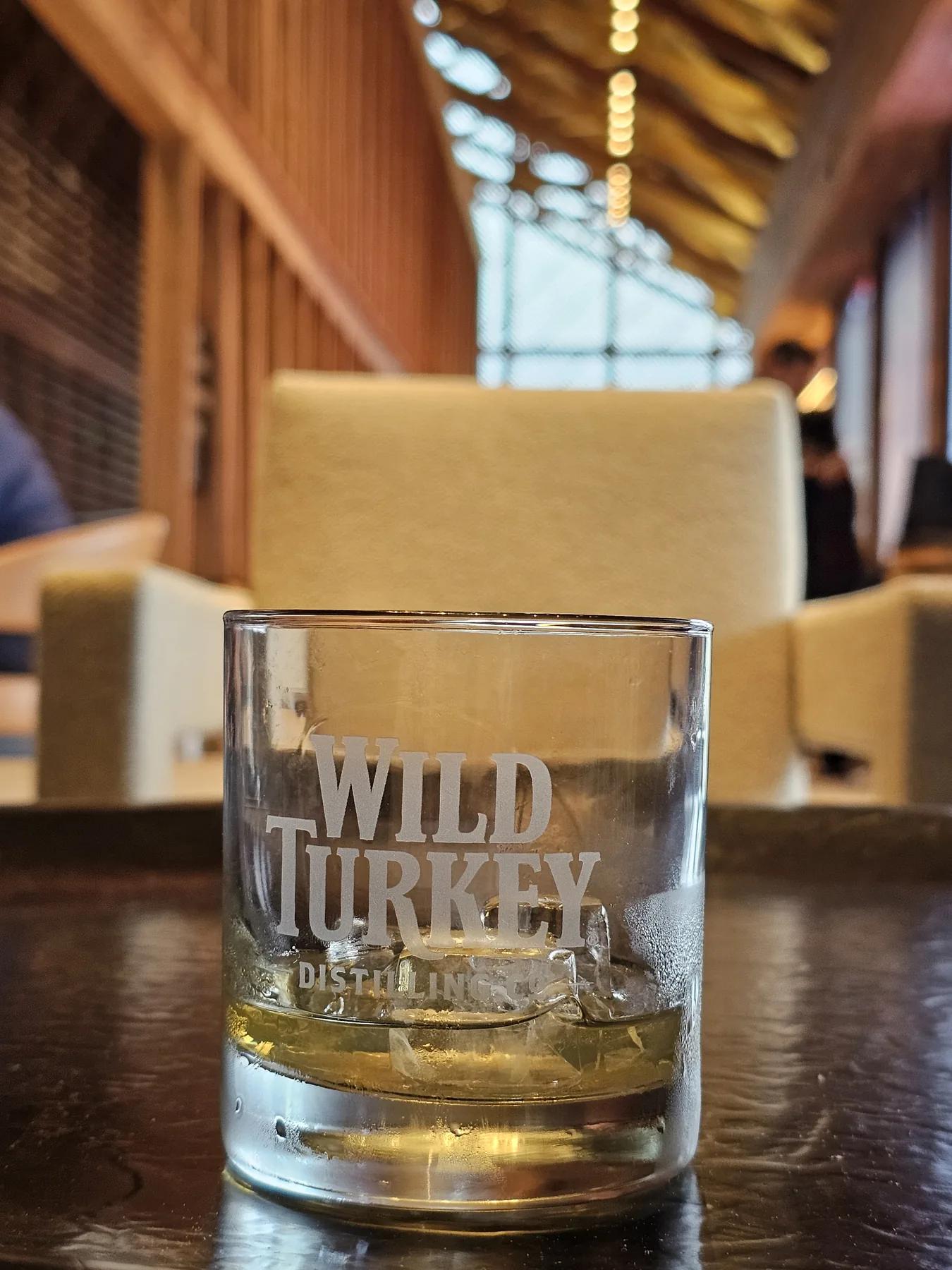 Three measured bourbon pours arranged from light to rich