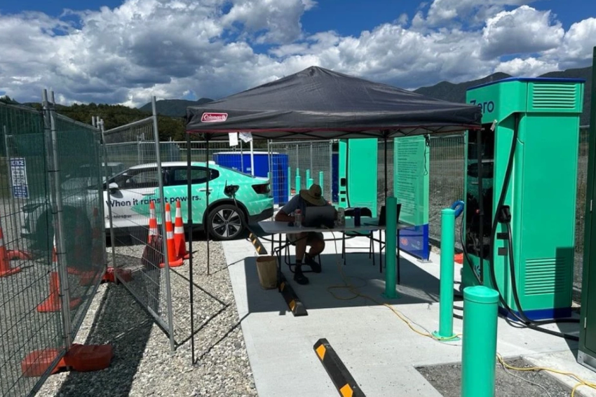A Meridian engineer on site at Springs Junction, sitting under a gazebo working at a table.