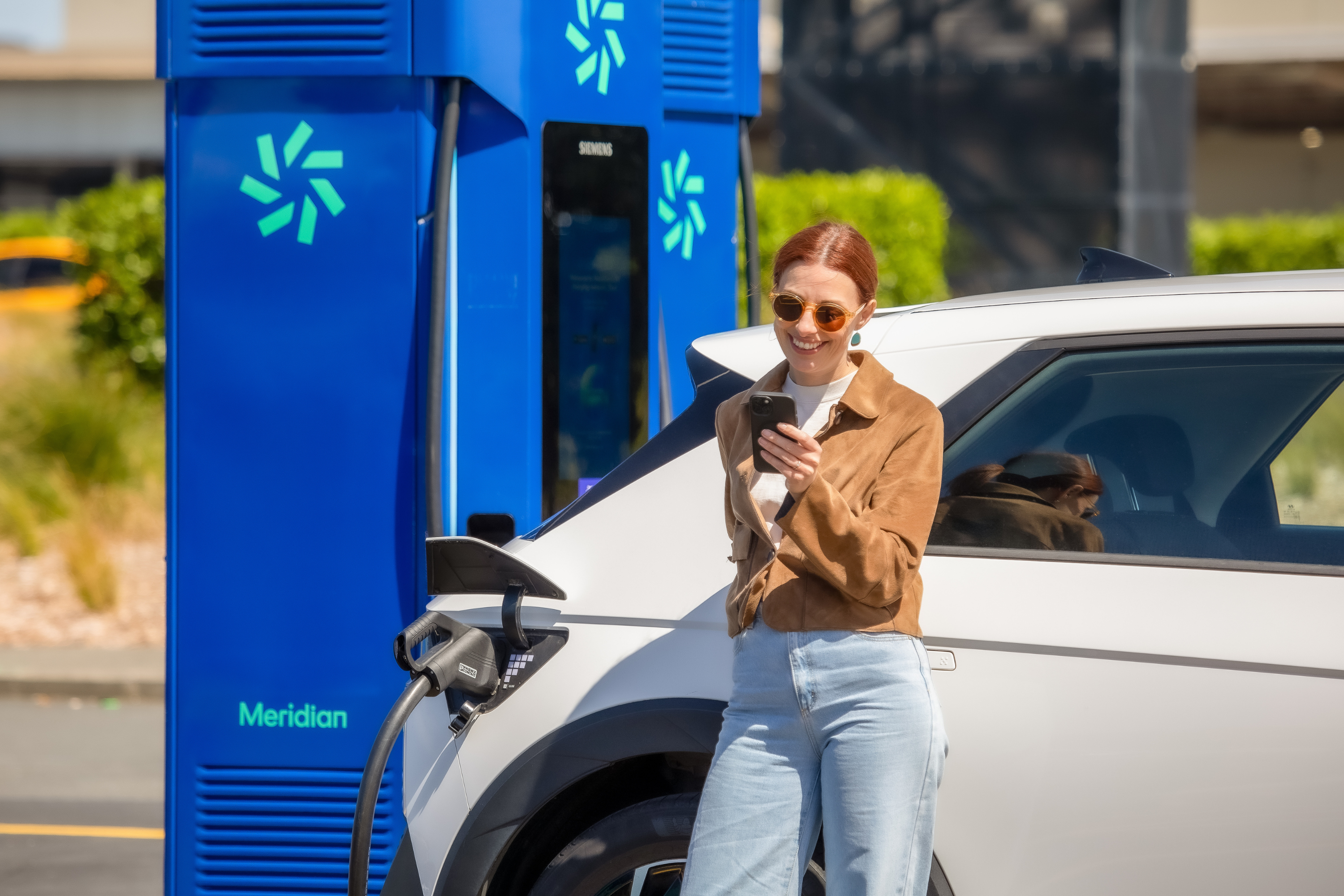 A woman charging her EV with Meridian's Zero EV charger.