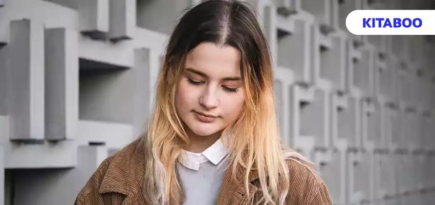 Attractive young woman draws with a pencil on a digital tablet blog