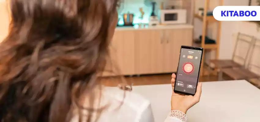 Woman hands holding phone with smart app for home lighting. person in apartment holding telephone with touchscreen vlog