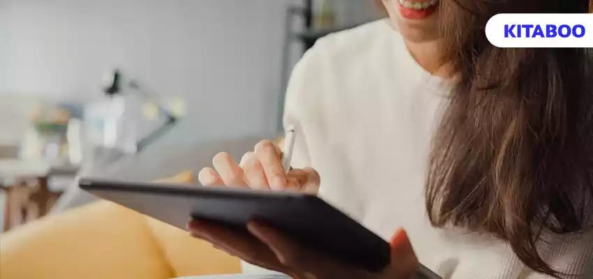 Close up freelance asian lady casual wear using tablet online learn in living room at house. work from home, remotely