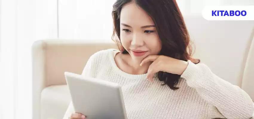 Pretty woman reading e-book vlog