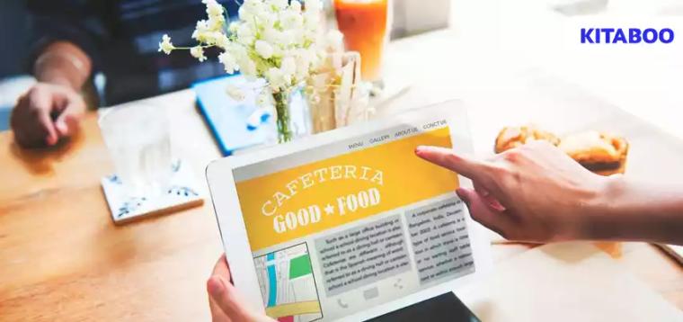Closeup of hands holding tablet screen showing cafeteria review