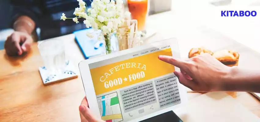 Closeup of hands holding tablet screen showing cafeteria review