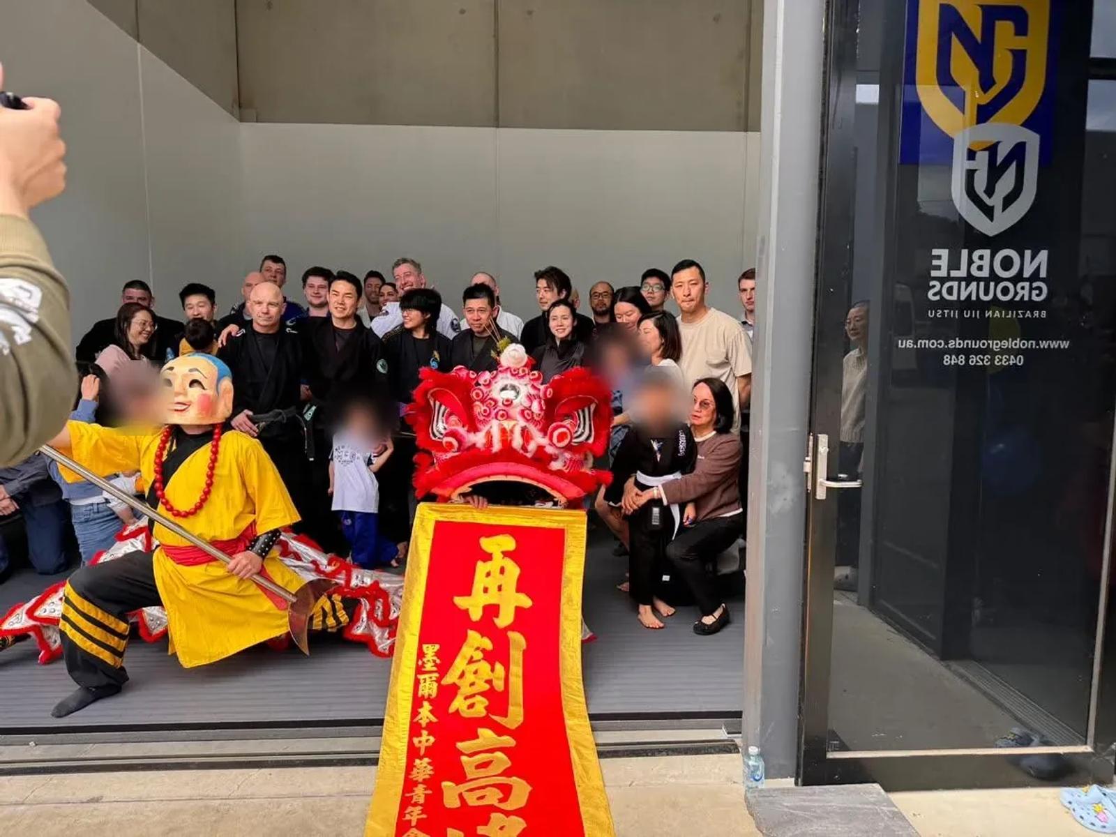 Everyone who came to the Noble Grounds BJJ grand opening, gathered outside the academy with the lion dance troupe